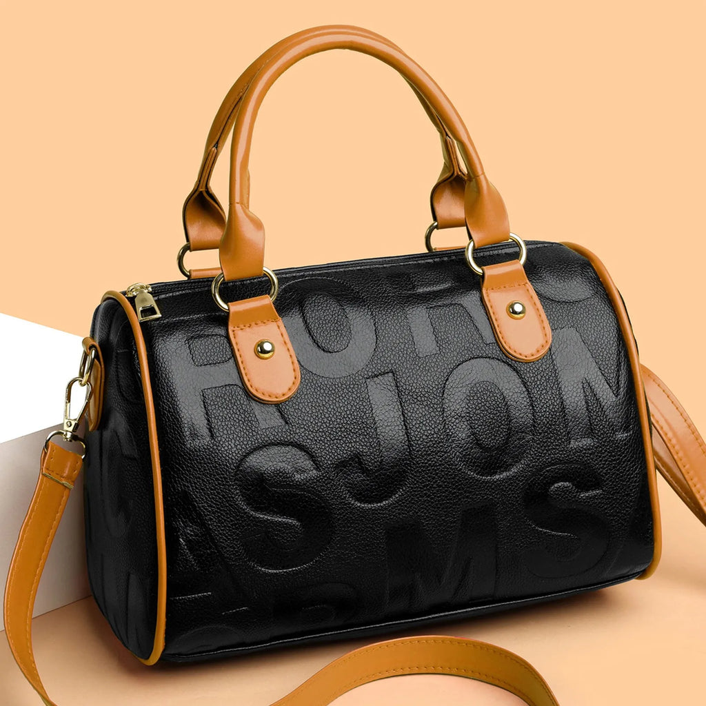 Brown cylindrical crossbody bag with three straps on a plain background