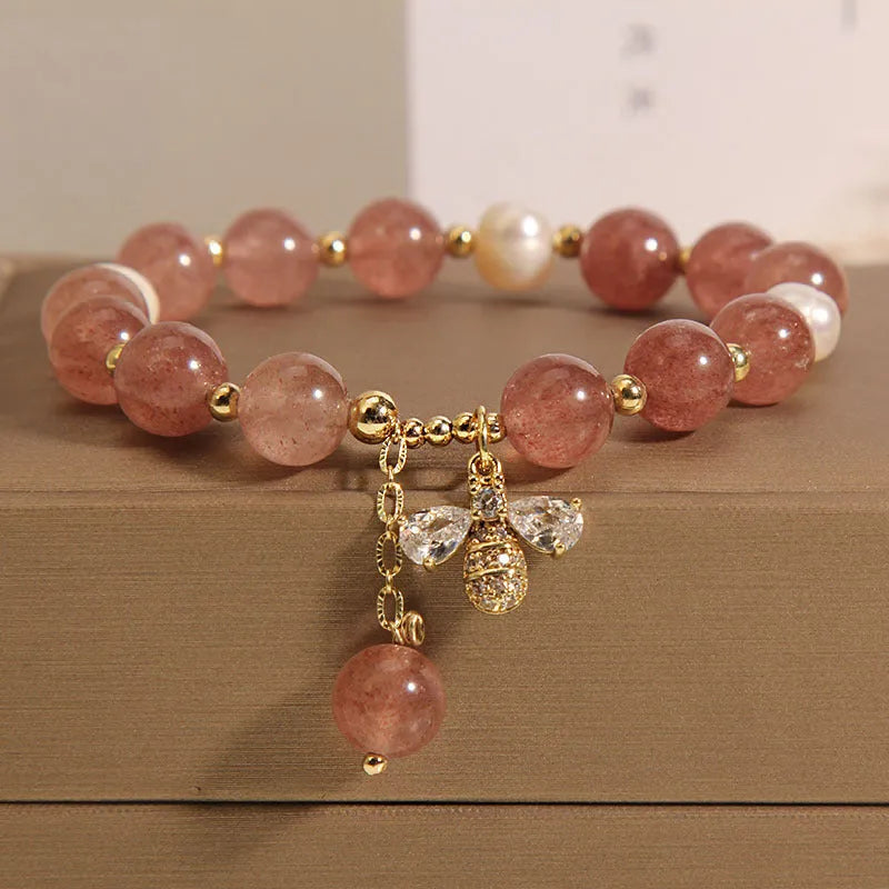 Women's bracelet with pink strawberry quartz stones, white freshwater pearls, and zircon details on an alloy chain.