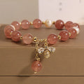 Women's bracelet with pink strawberry quartz stones, white freshwater pearls, and zircon details on an alloy chain.