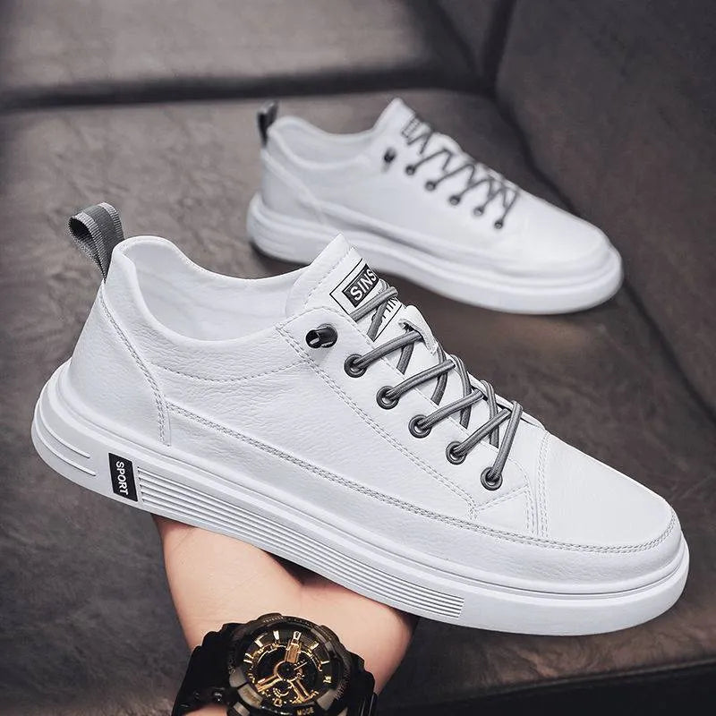 Men's casual white PU leather shoes with round toe and low flat heel on a beige background.