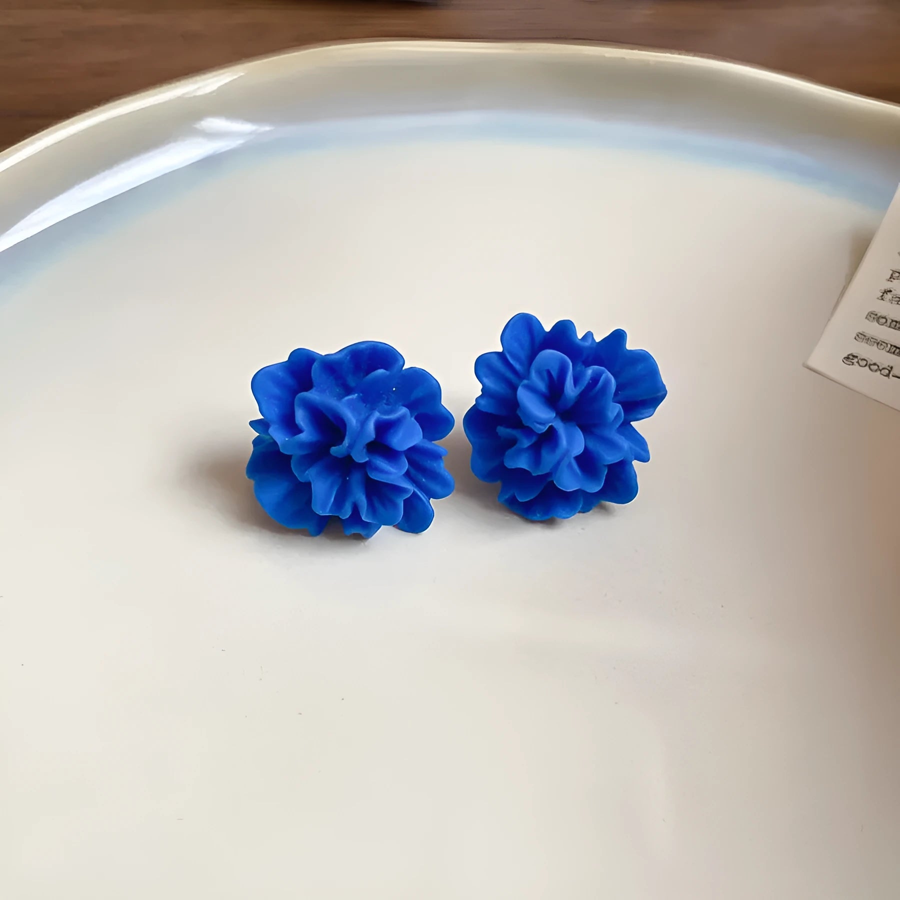 Women's geometric fabric earrings with blue resin flowers on round silver needle cloth base