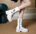 Women's black mid-calf knight boots with large metal buckle and side zip on a white background.