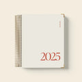 Cherry red A5 daily schedule coil notebook with spiral binding open on desk