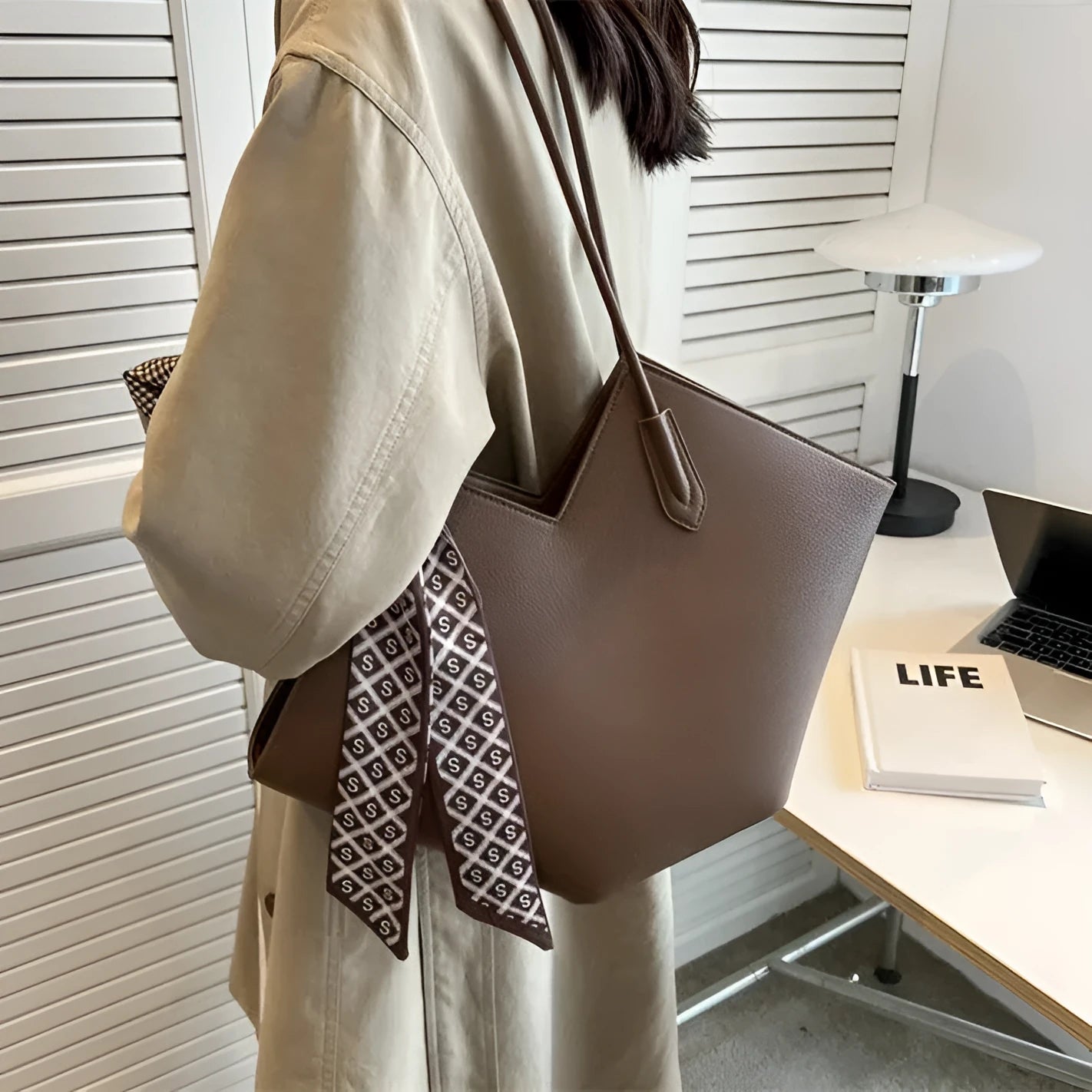 Women's large black PU leather shoulder bag with horizontal square shape and sandwich pocket.