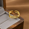 Gold geometric open ring for women made from electroplated copper.