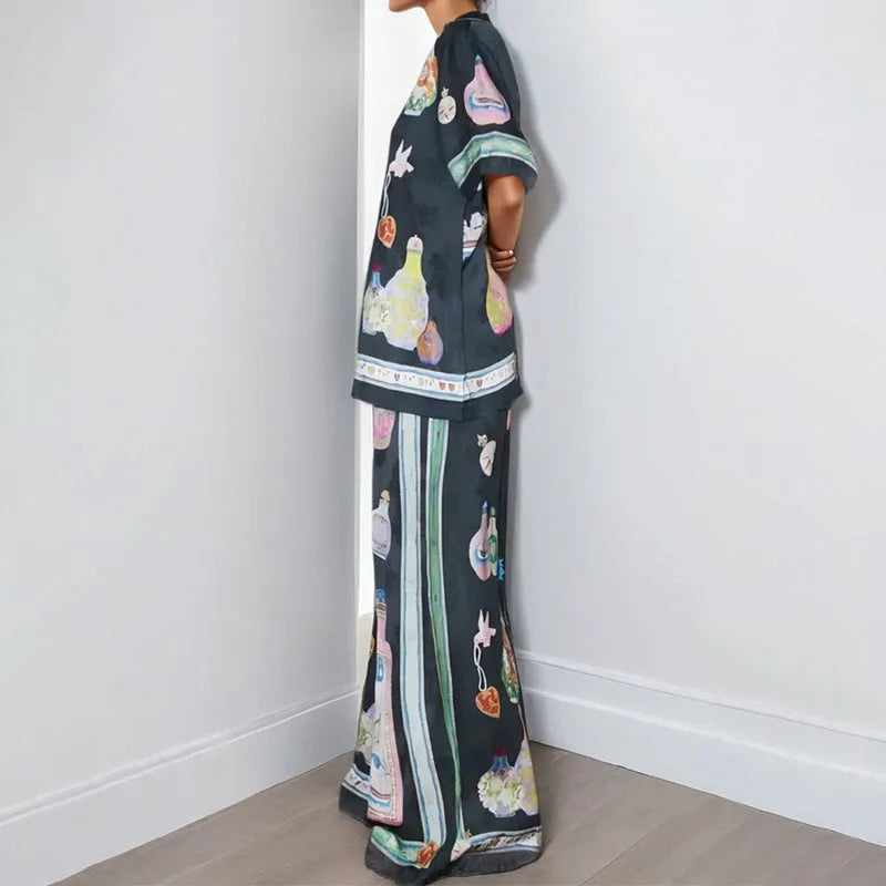 Black women's cardigan and trouser set with cartoon print, showing front view.