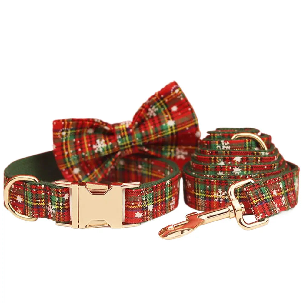 Green fabric Christmas pet collar and leash set with snowflake pattern, including a vest and decorative bow.