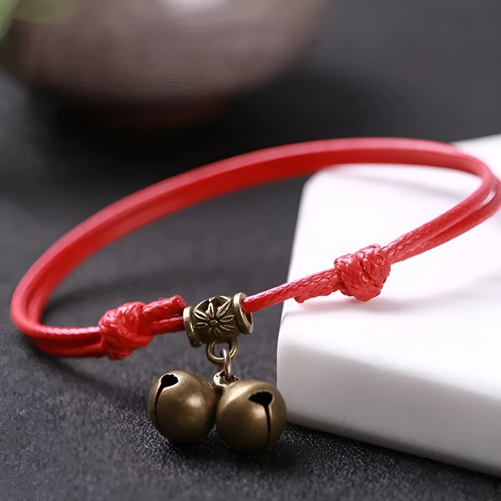 Nylon rope dog collar with brass buckle shown in black, red, and coffee colours, some with an attached brass bell.