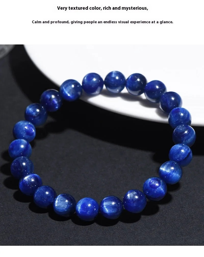 Polished blue crystal bracelet with geometric beads and Ruyi charm, shown in trade fair gifting context
