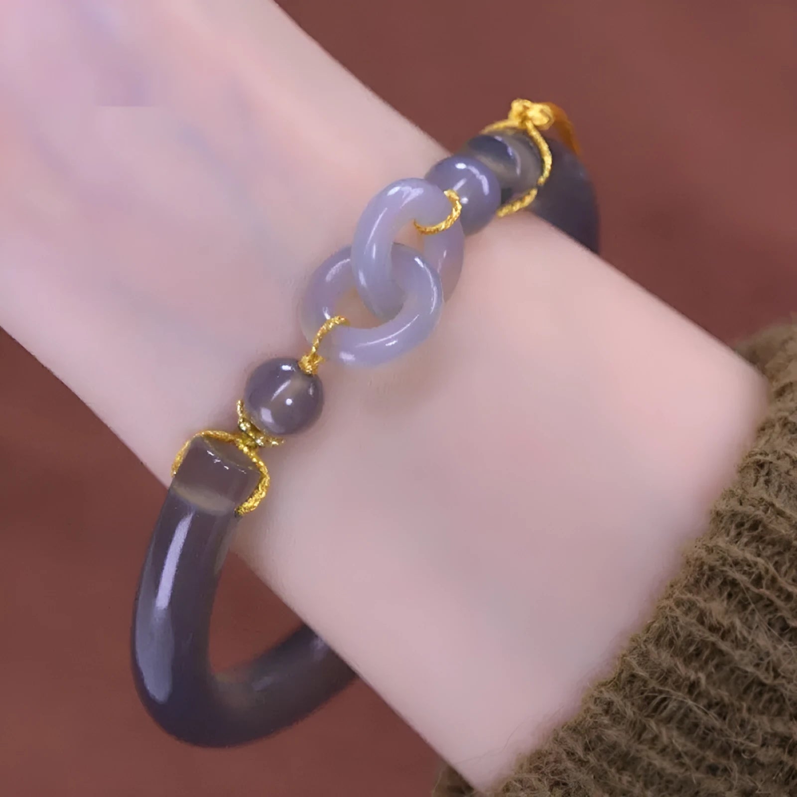Grey smoke purple agate half bracelet with a metal ring buckle closure on a wrist.