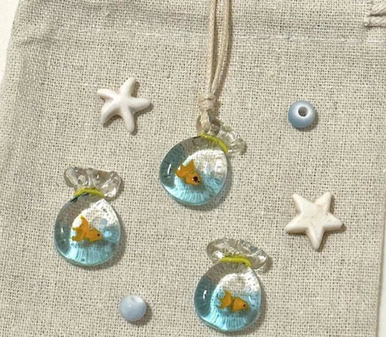 Women's pendant necklace with coloured glaze joker charm on a cotton and linen clavicle chain.