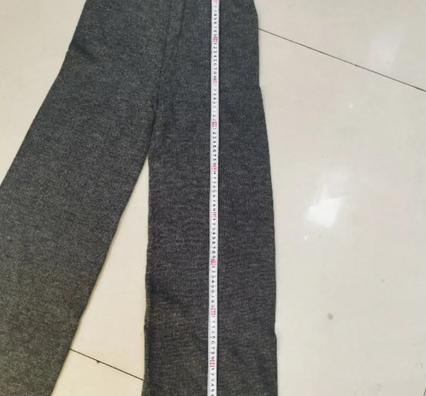 Women's dark grey acrylic knit two-piece suit with matching top and trousers.