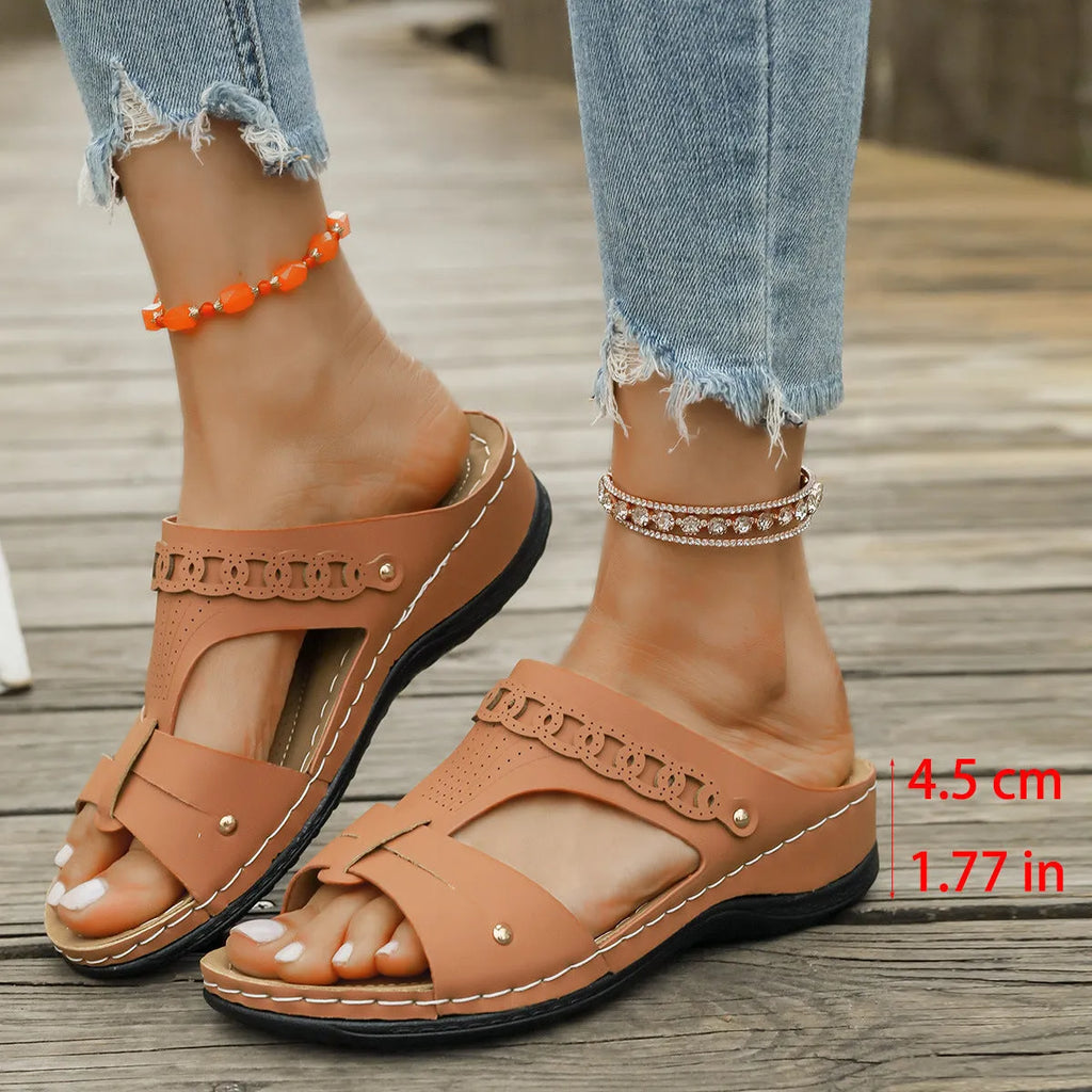 Roman-style slippers with a slope heel and fish mouth toe design in PU leather, shown in beige colour.