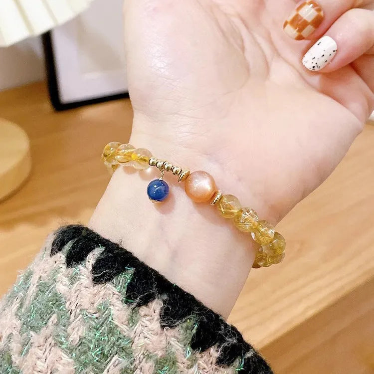 Women's gold rutilated quartz sunstone crystal bracelet with round beads in diamond pattern