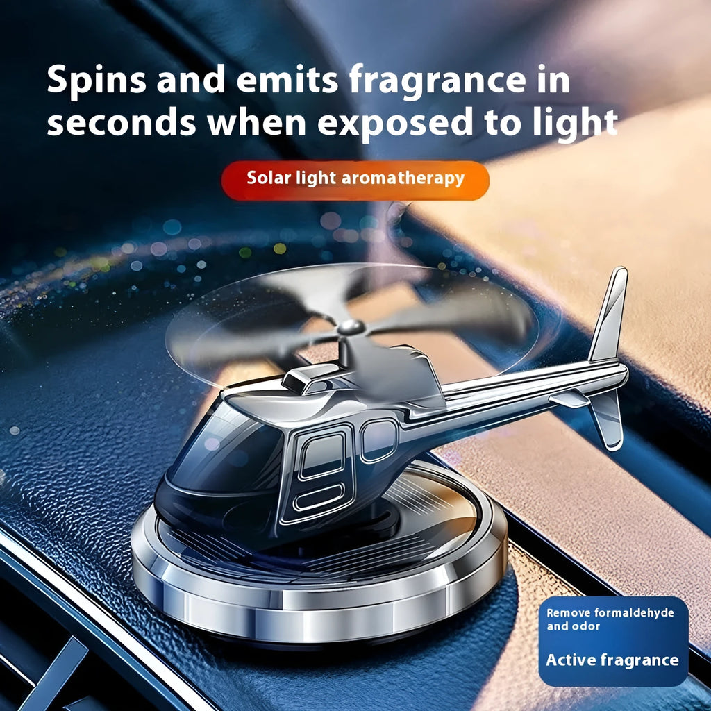 Silver metal solar-powered helicopter car ornament with rotating perfume diffuser blades.