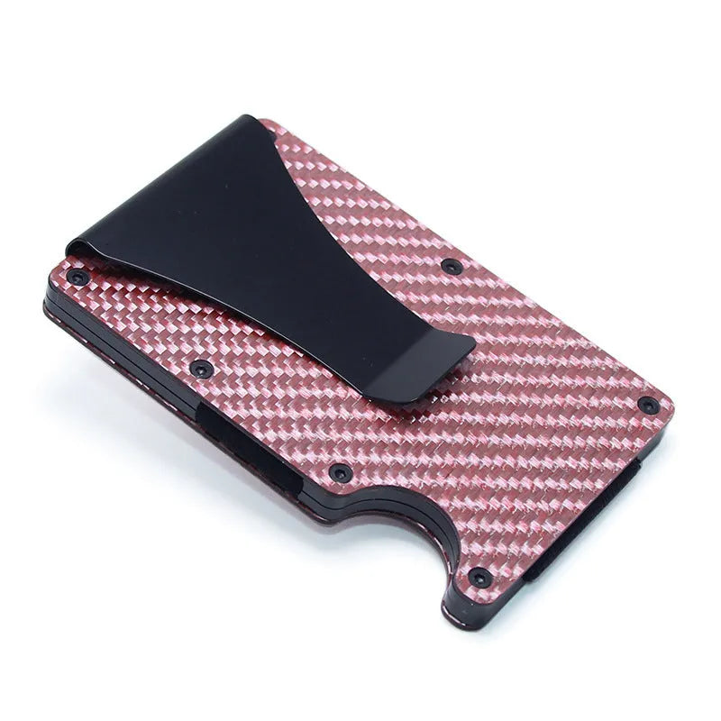 Geometric carbon fibre and aluminium business card holder, 8mm thick, on a table.