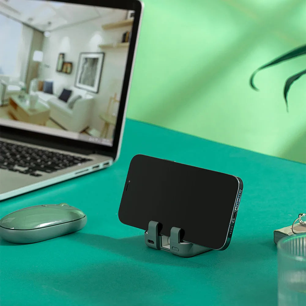 Red multi-function bracket mobile power supply showing USB-C and Lightning ports and integrated phone holder.