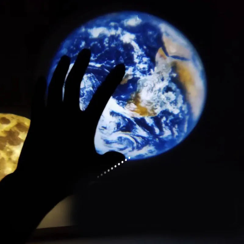 Earth and Moon projector night light with flexible hose bracket on a bedside table