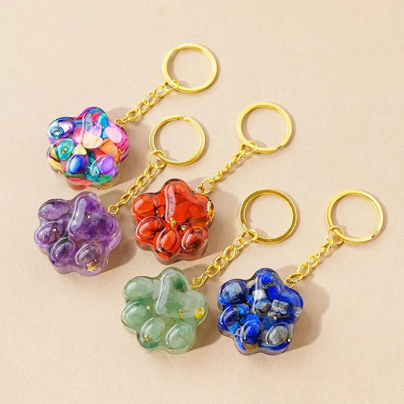 Small metal cat's paw keychain pendant with a set natural crystal charm.