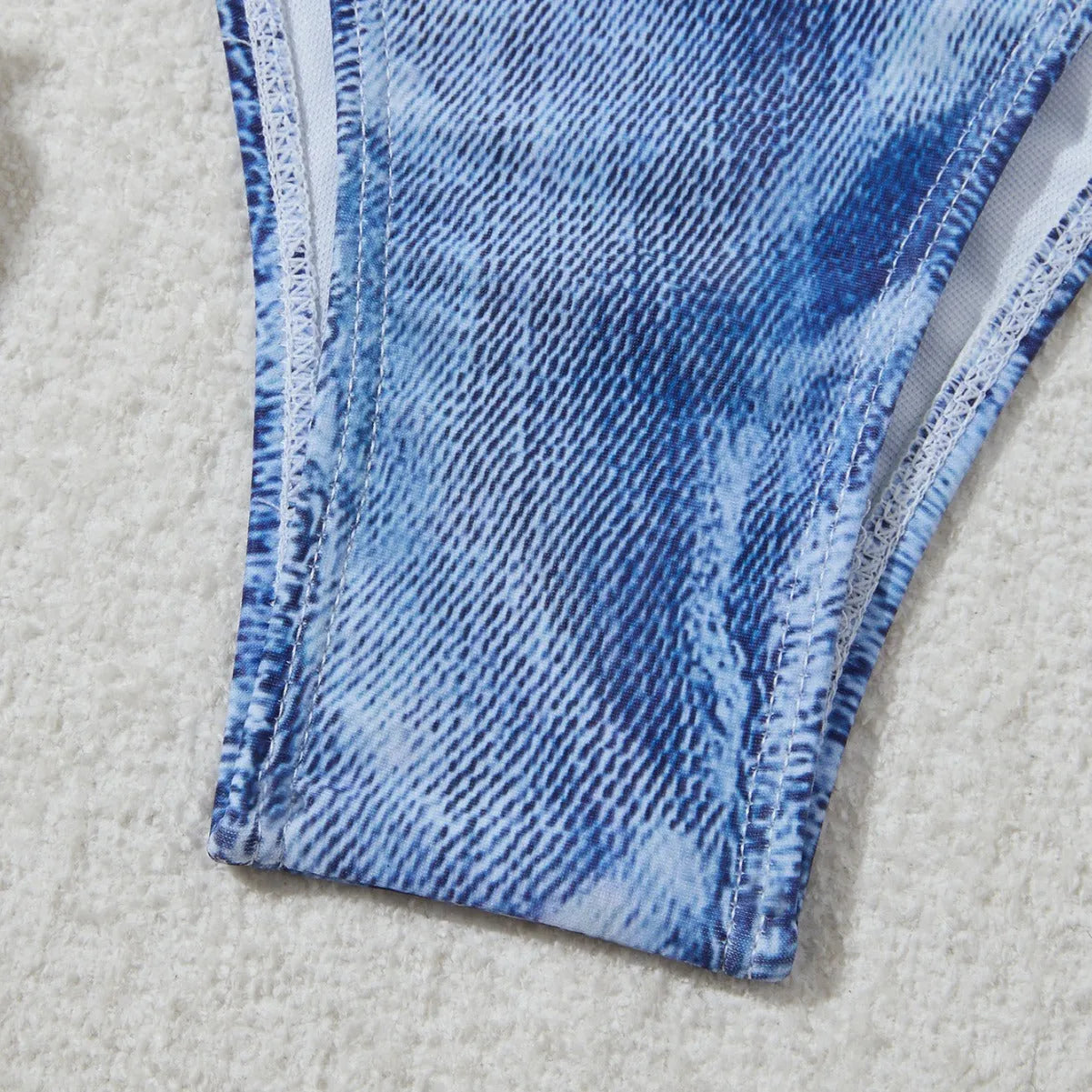 Denim blue printed women's bikini set with strap design on a white background.