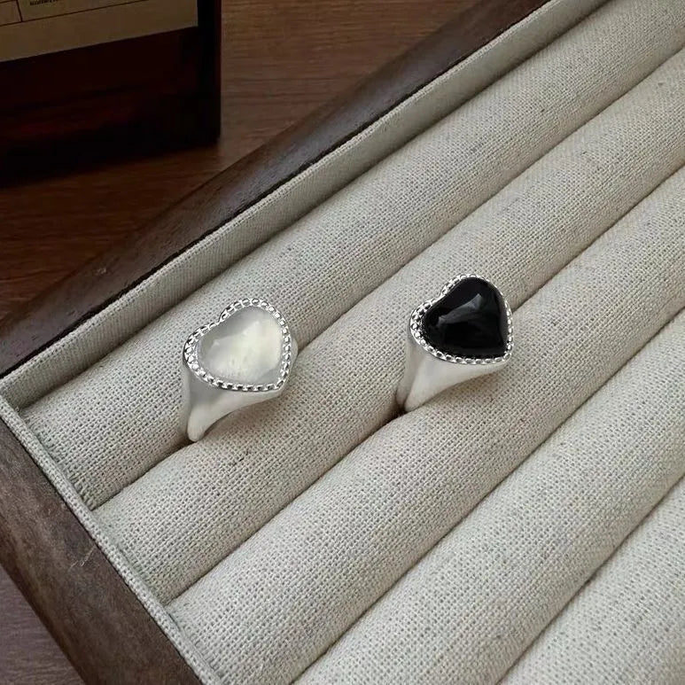 Sterling silver ring with a heart-shaped black agate stone and an adjustable open mouth design.