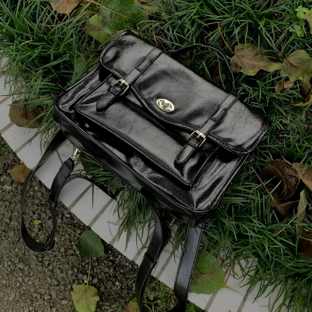 Black college messenger bag in oil wax leather style with shoulder strap