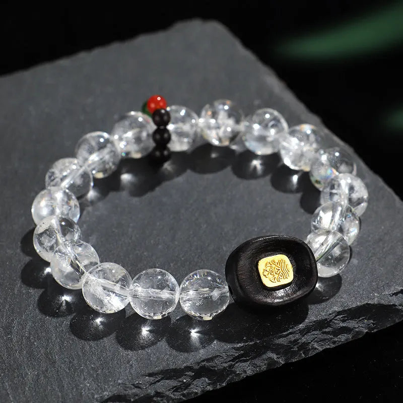Handmade natural white crystal ebony bracelet with five warp design on wooden background