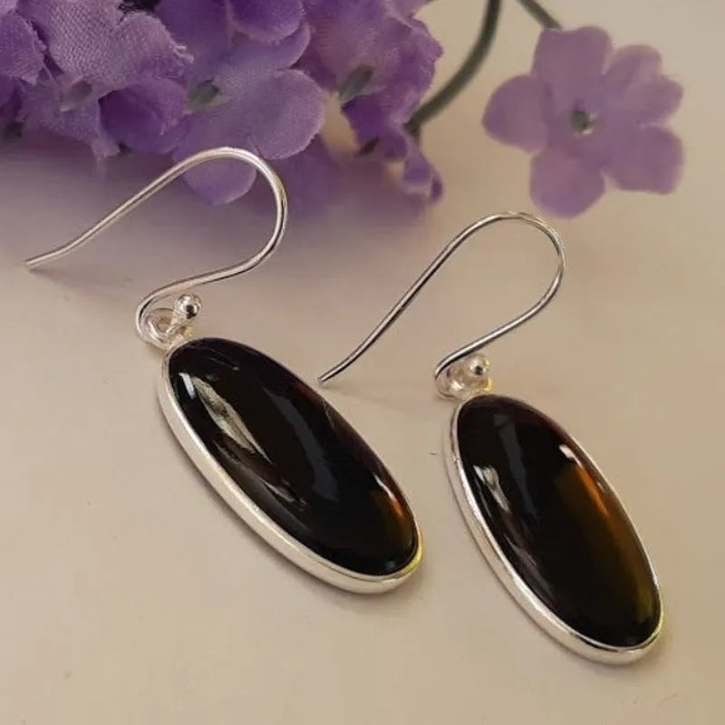 Black oval geometric earrings with Chinese style design on an electroplated alloy construction.