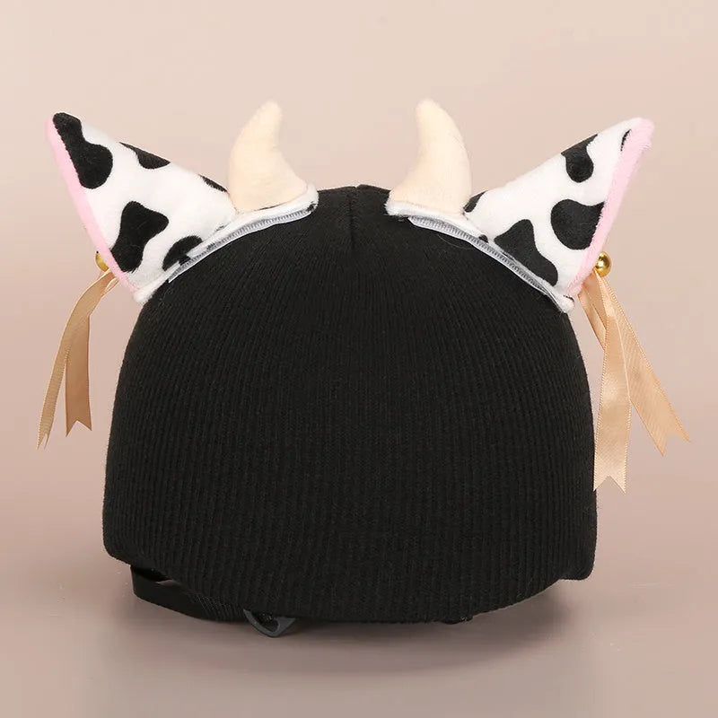 Plush cartoon-themed cover set on a medium motorcycle helmet with soft ear decorations.