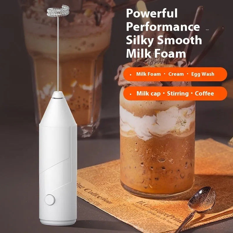 Compact black handheld electric milk frother with a stainless steel whisk and USB charging port.