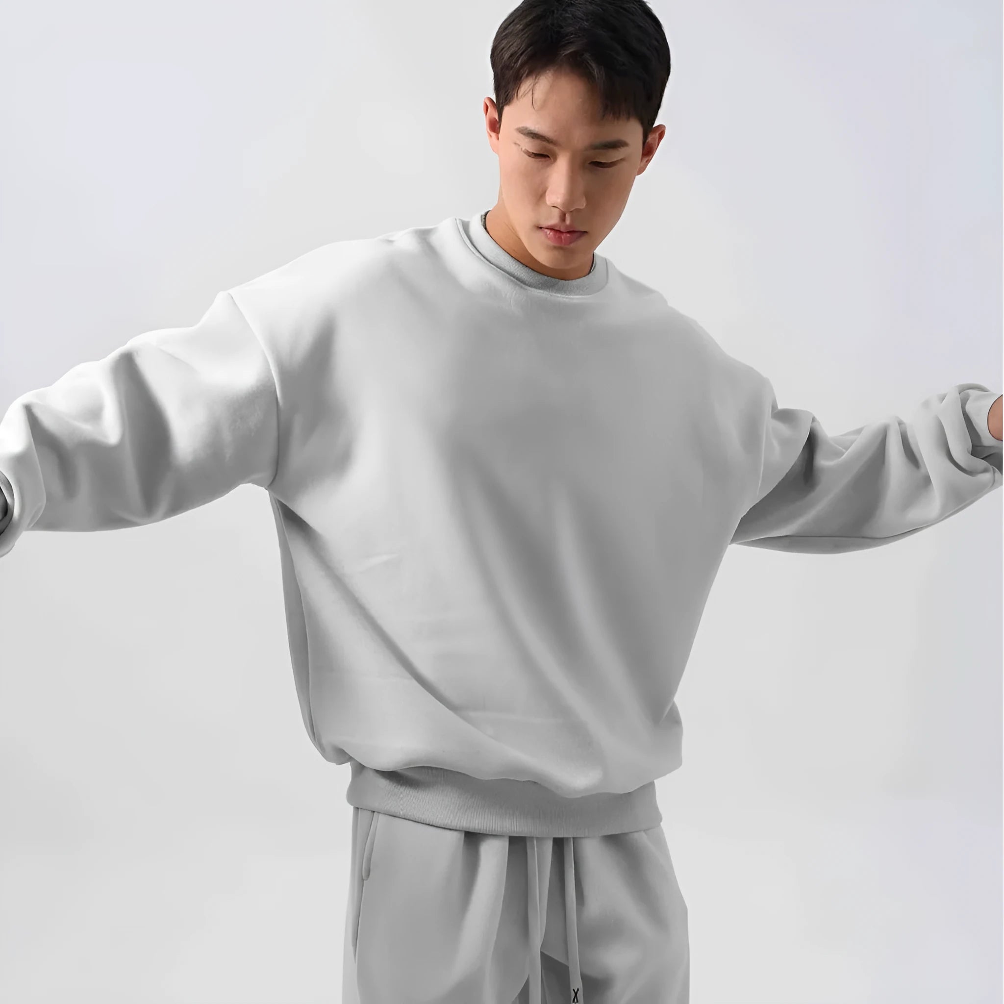 Men's polar fleece sports suit showing long-sleeved top and padded trousers in light grey colour