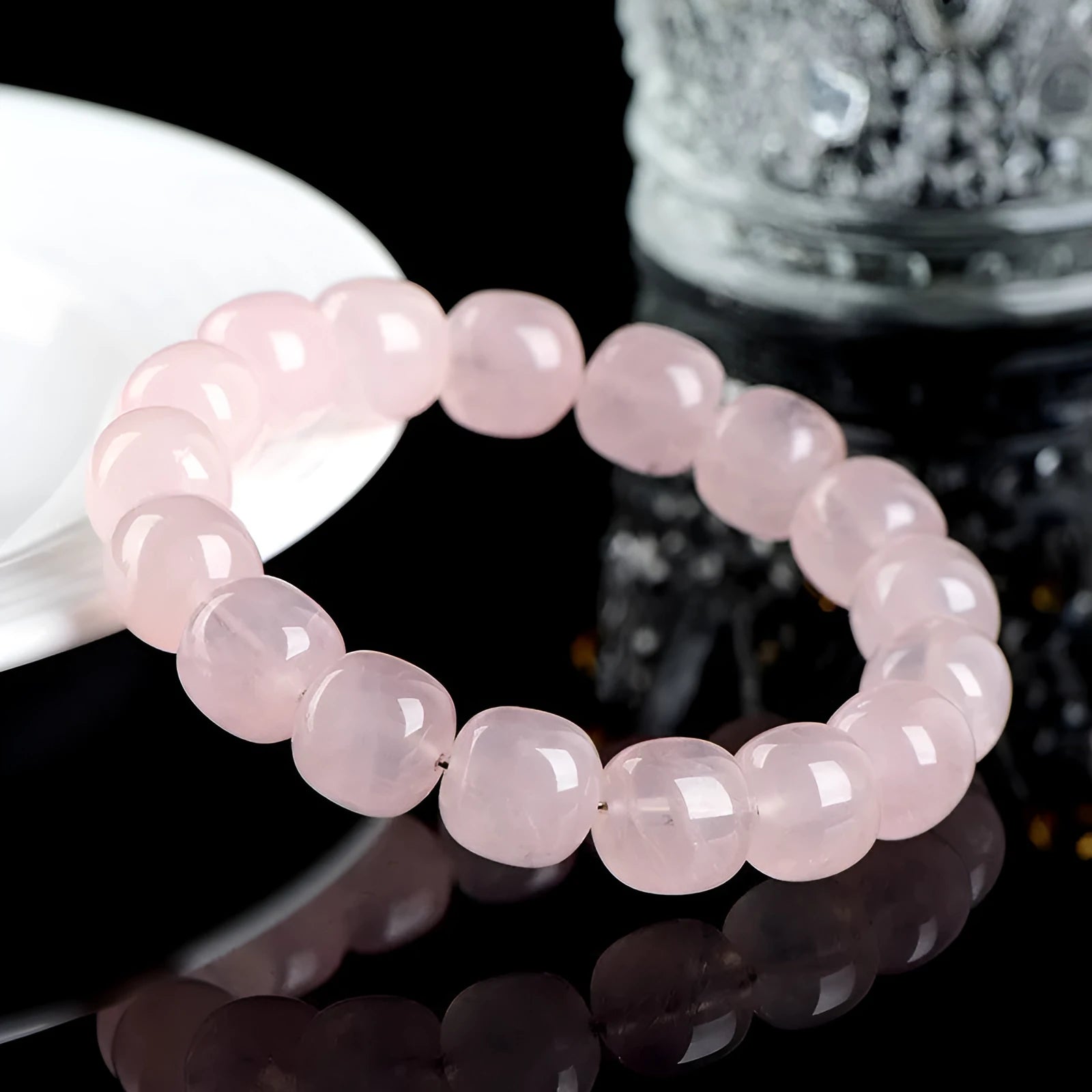 Natural pink crystal barrel bead bracelet with 11-12mm geometric design on wrist