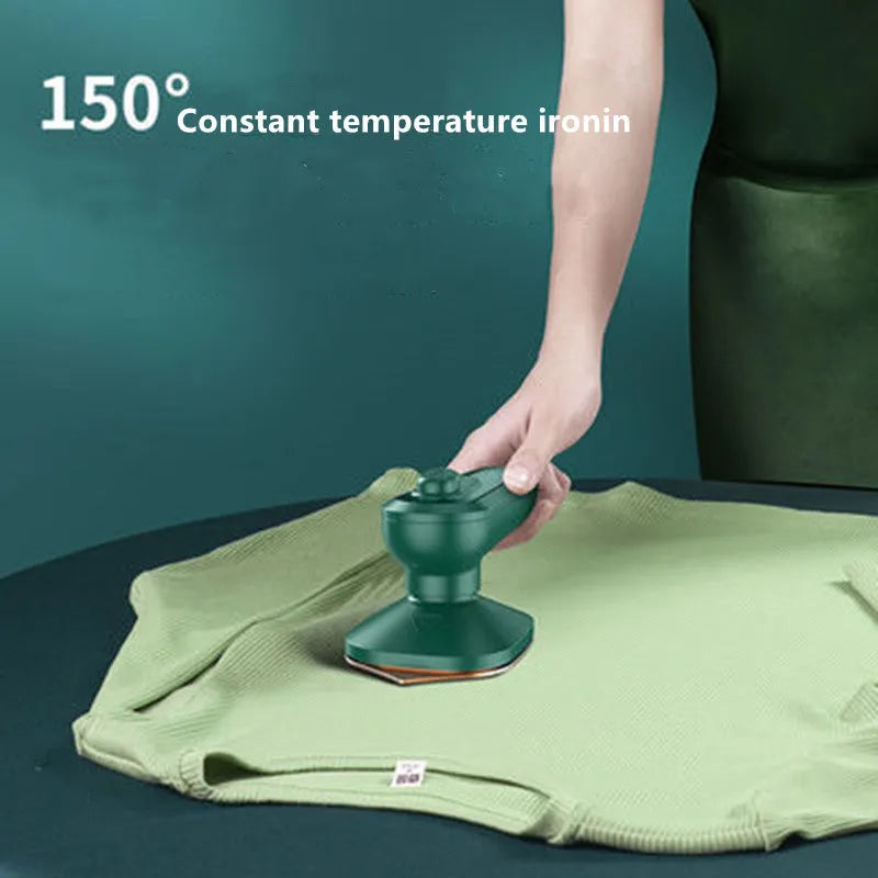 Dark green portable hand-held steam ironing machine with a ceramic panel.