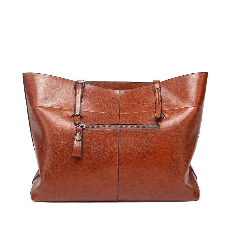 Horizontal brown cowhide leather crossbody handbag showing two main compartments and a front pocket.