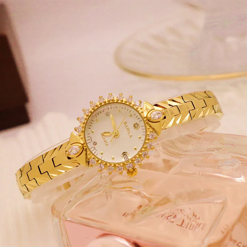 Vintage gold-toned ladies bracelet watch with diamond embossed links and quartz movement