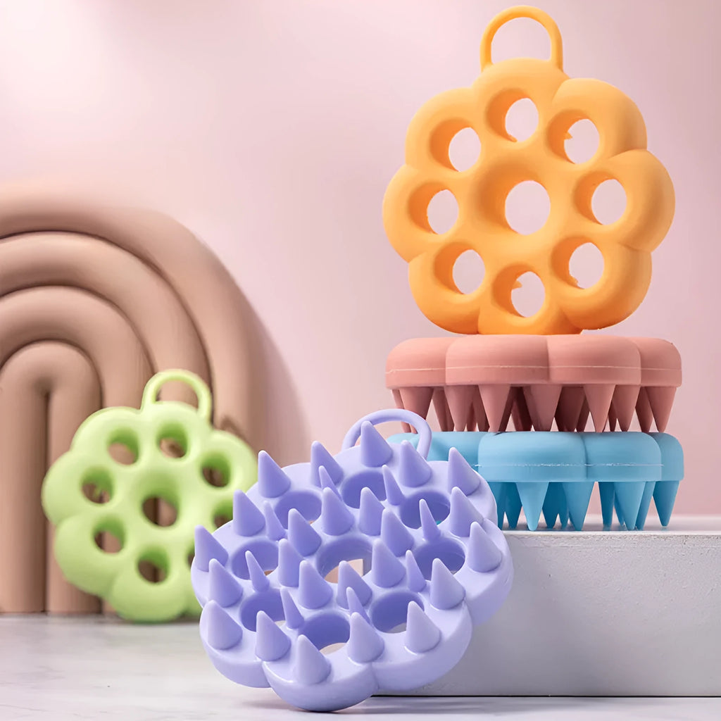 Blue silicone pet grooming brush with soft pins and ergonomic handle for wet or dry use.