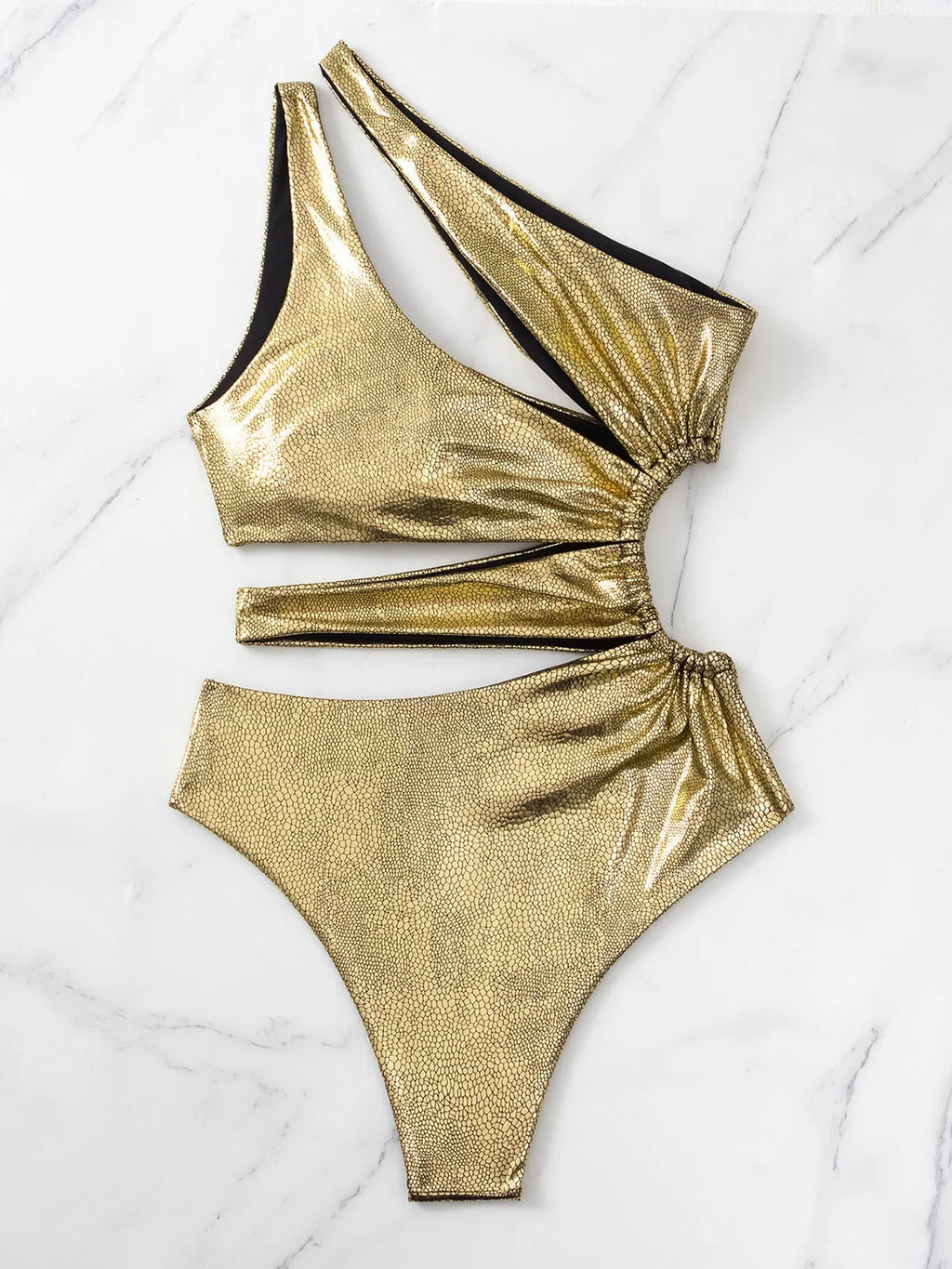 Women's gold backless one-piece swimsuit on a mannequin, showing sleeveless design.