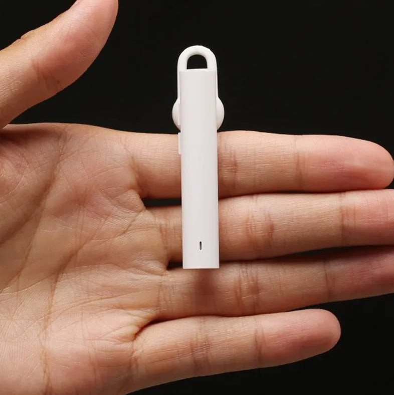 Compact black and white wireless Bluetooth earpiece showing 5.6 cm size dimensions