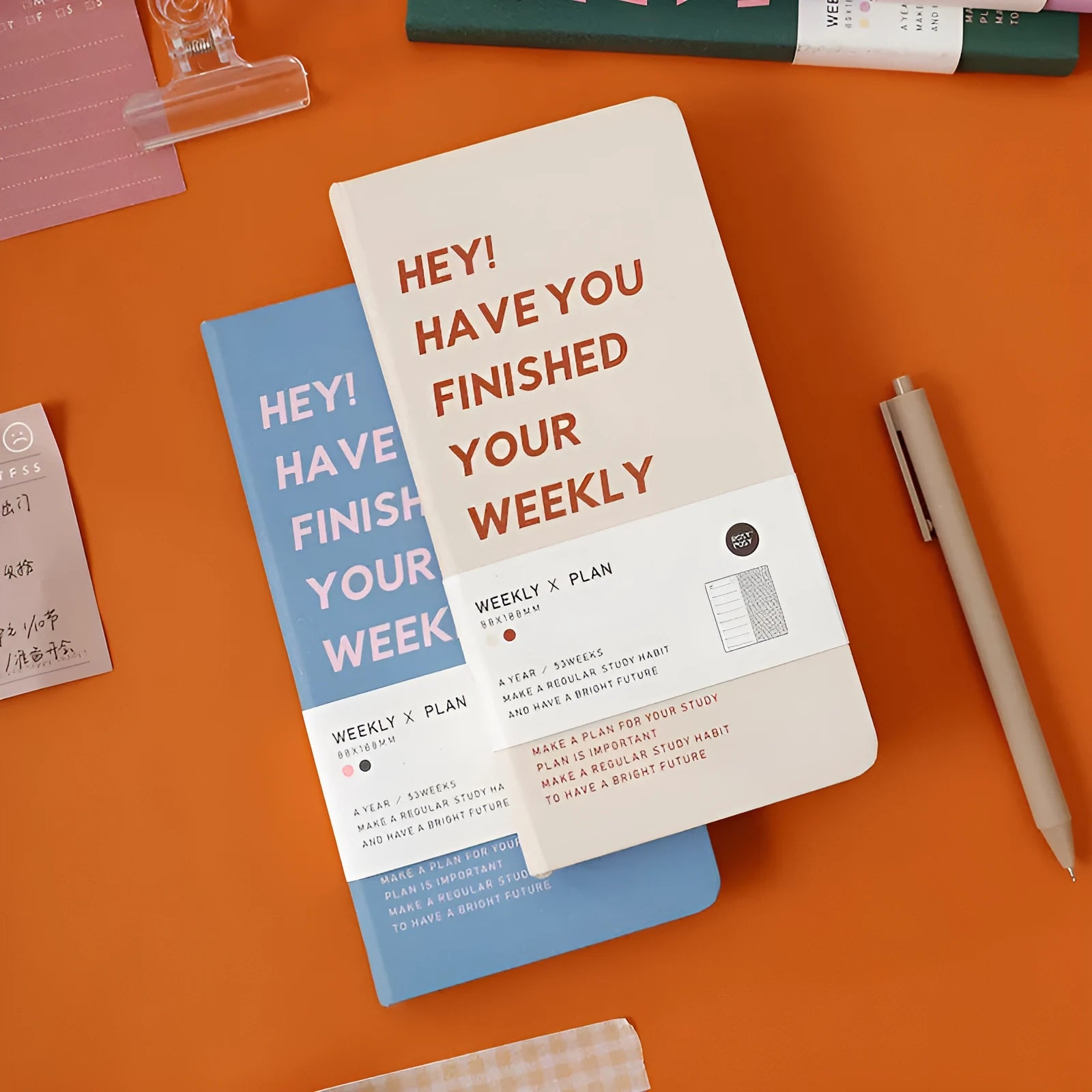 Weekly plan diary handbook showing colour options: blue, brown, green, purple with 100-page internal paper section