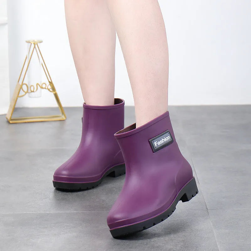 Women's black mid-calf rain boot made of PVC with a low heel.