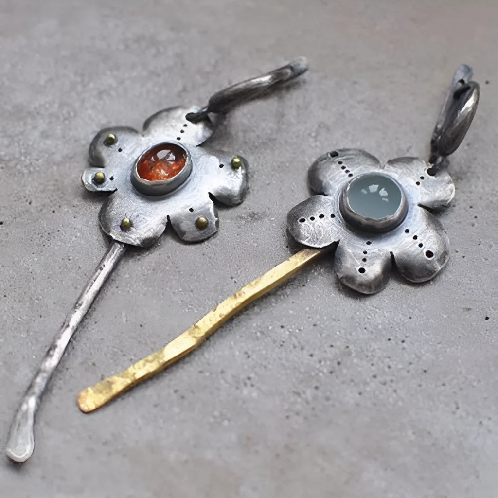 Geometric floral retro earrings with two-tone asymmetrical design and long drop style.