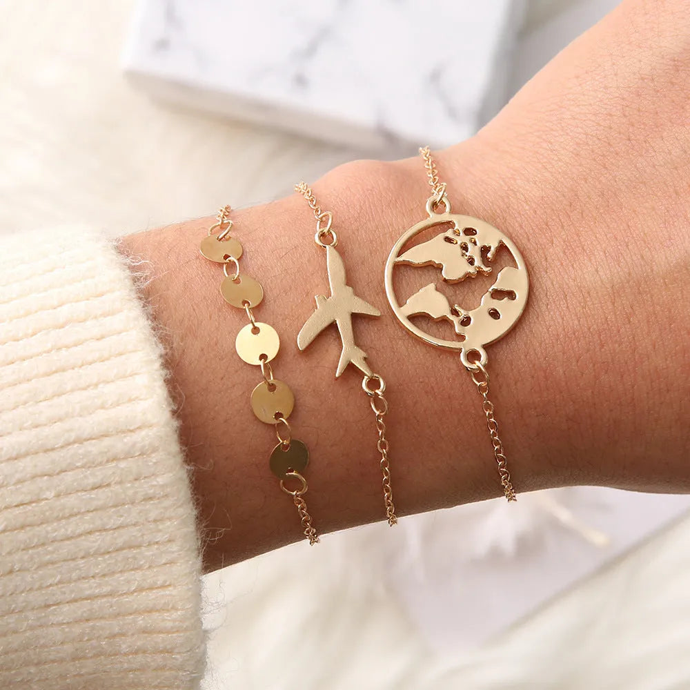 Three bohemian aircraft map charm bracelets with heart-shaped alloy charms in electroplated finish