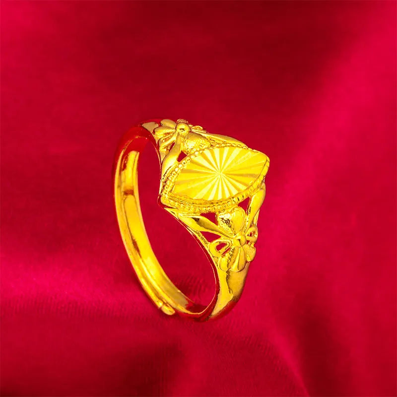 Gold-coloured geometric flower ring with textured surface and open design on brass