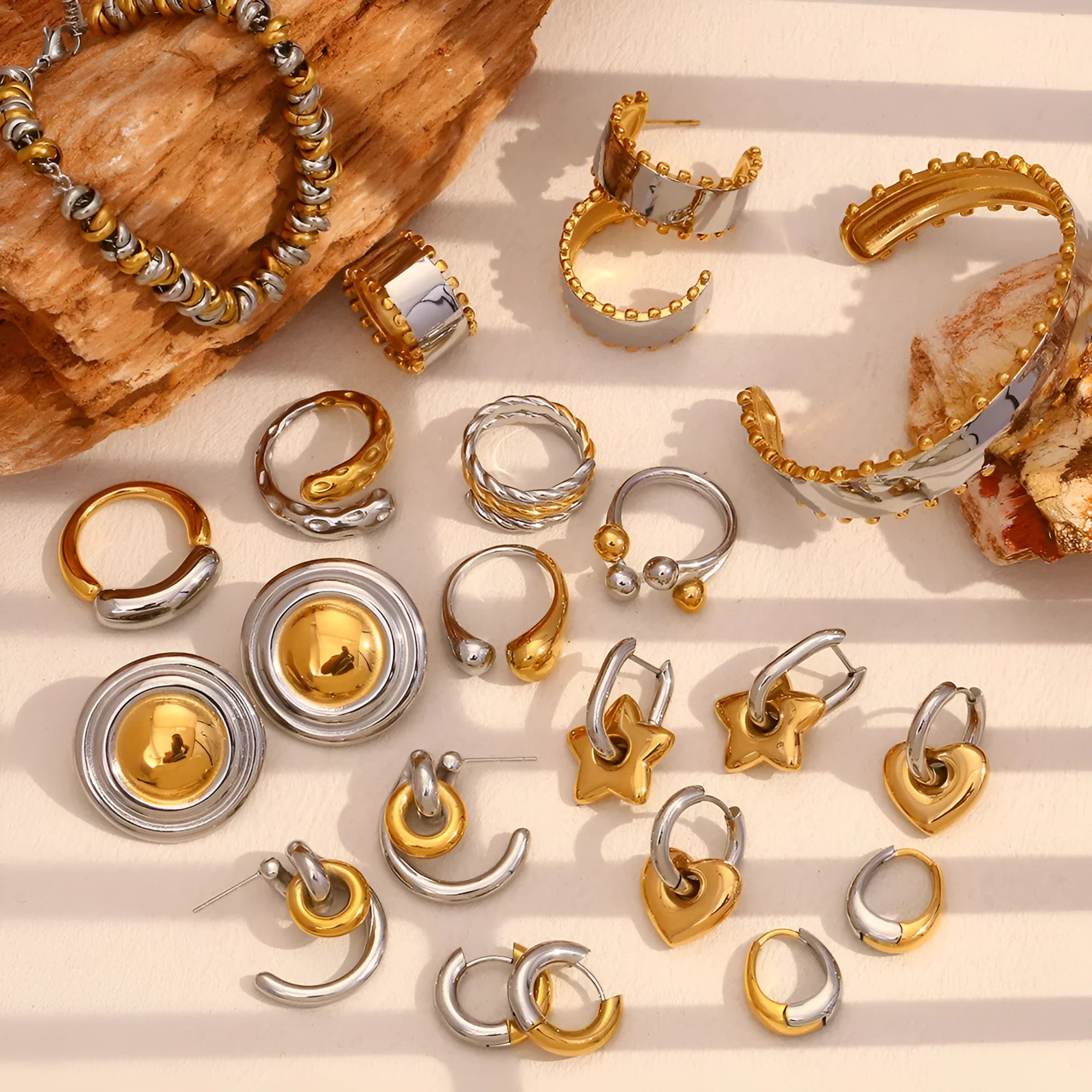 Gold coloured stainless steel jewellery set showing geometric earrings, necklace, and bracelet with round details.
