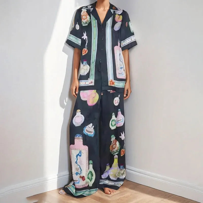Black women's cardigan and trouser set with cartoon print, showing front view.