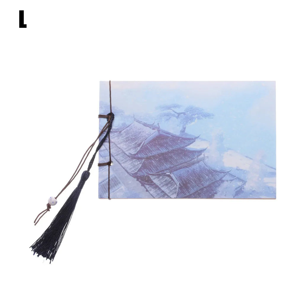 Kraft paper notebook with tassel bookmark showing hand-stitched binding and blank interior pages