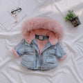Blue denim coat for girls with a hood and plush fleece lining, shown on a hanger.