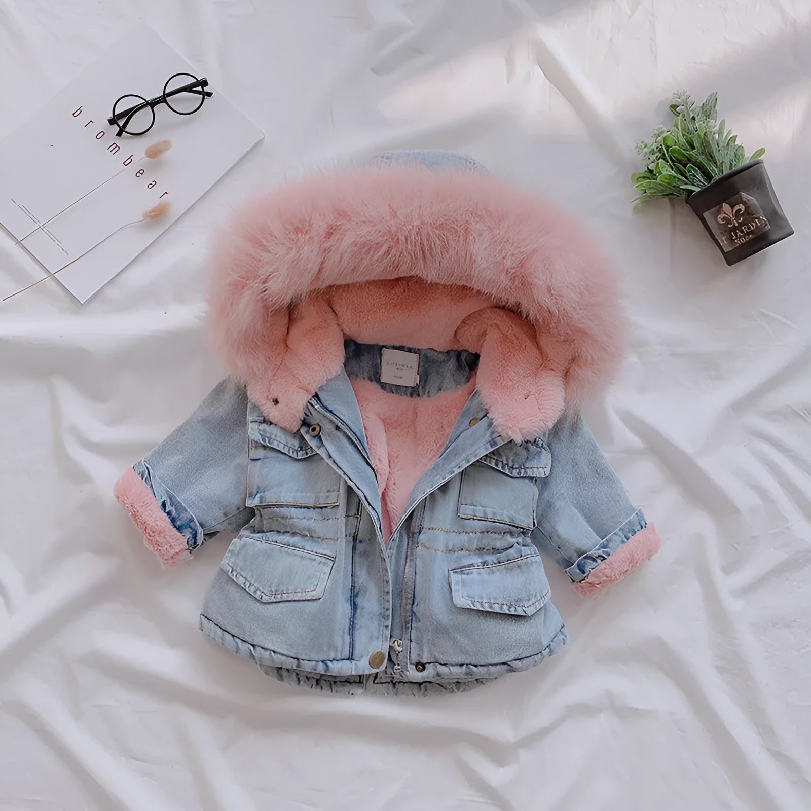 Blue denim coat for girls with a hood and plush fleece lining, shown on a hanger.