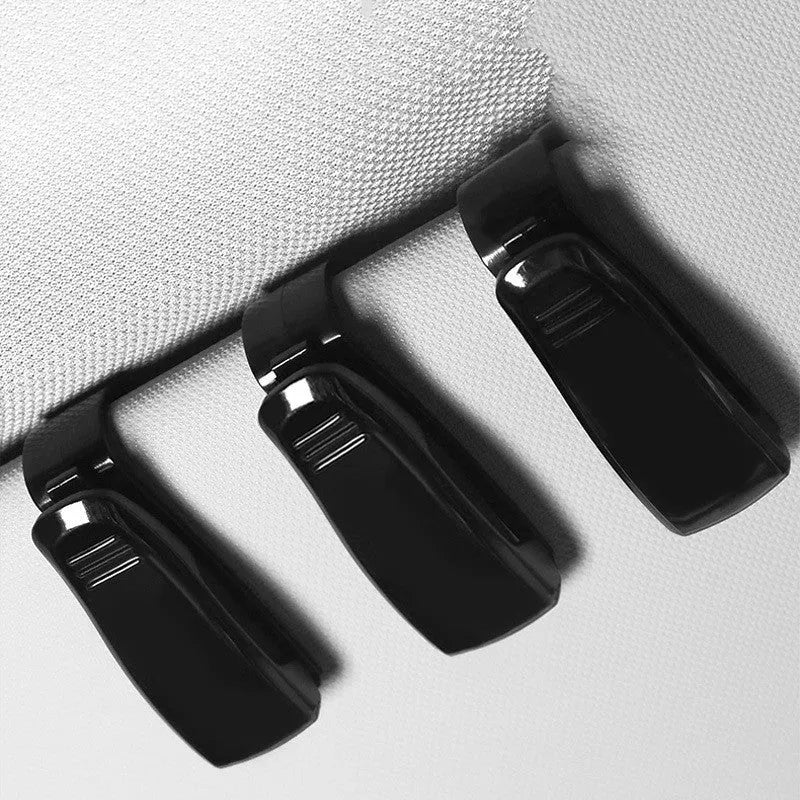 Black plastic clip for mounting glasses and cards on a car sun visor