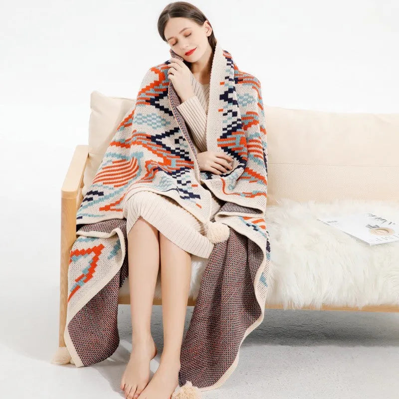 Acrylic bohemian-style blanket with tassel trim in a geometric pattern colour option